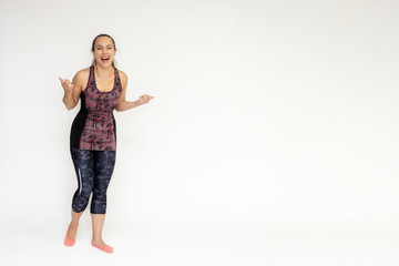 Full-length portrait on white background of beautiful pretty fitness woman girl in fashionable sportswear standing exercising in different poses, showing hands. Smiles Stylish trendy youth.