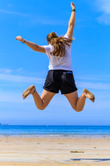 girl jumping on the beach