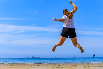 girl jumping on the beach