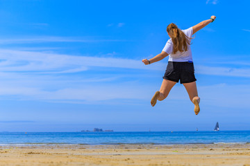 Naklejka premium girl jumping on the beach