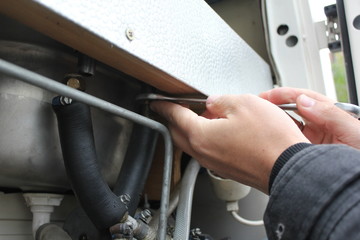mechanical working on car close up. hands with tool