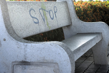 white stone bench with a painted of stop
