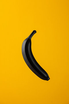 Black Banana On Yellow Background