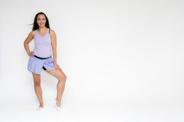Fototapeta na wymiar Full-length portrait on white background of beautiful pretty fitness girl woman in trendy tennis sport uniform, with different emotions in different poses, shows hands. Smiles. Stylish trendy youth.
