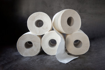 Rolls of toilet paper on a dark background.The Topic Of Hygiene
