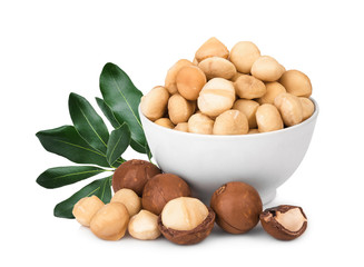 macadamia fruit in the white bowl with leaf isolated on white background