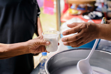 Free food for poor and homeless people donates food to food less people : The poor have been sharing food from the kinder society to Relieve Hunger : Social concept of poor people sharing