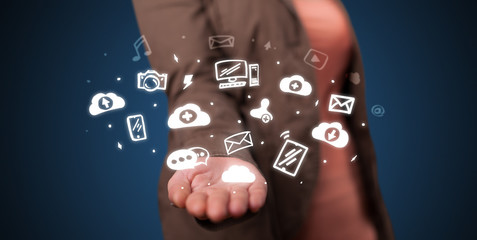 Hand holding application icons and symbols in her hand