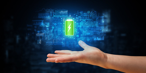 Elegant hand holding battery with full of energy