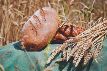 bakery products in a basket on a wheat field