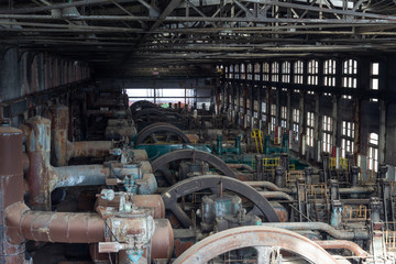 Machinery in an old steel mill, paint and rust patina, horizontal aspect