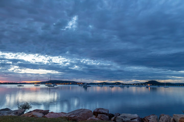 Hints of Pink in a Dawn Waterscape with Boats in the Bay