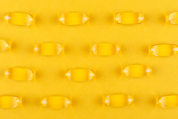 yellow capsules on yellow background, abstract pattern