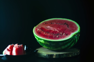 sliced juicy ripe watermelon on a dark background for the menu