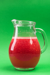 Jug with Fresh Summer Refreshing Watermelon Juice on Green Pastel Background