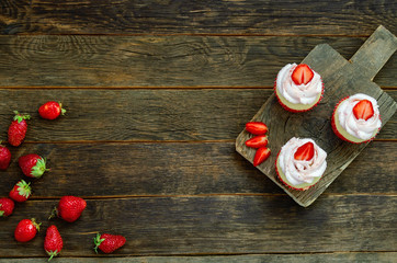 Cupcake with sparkler on table on wooden background