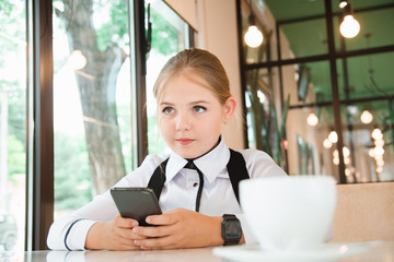 Charismatic girl as a businesswoman in cafe at lunch. Business youth.