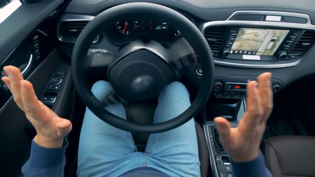 Stirring wheel is revolving without being moved by the driver. Self-driving steering wheel of an autonomous autopilot driverless car.