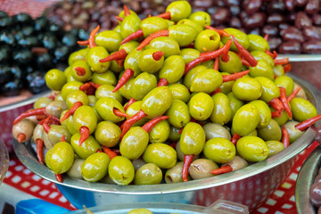 Marinated olives with red chili inside sold on farmers market