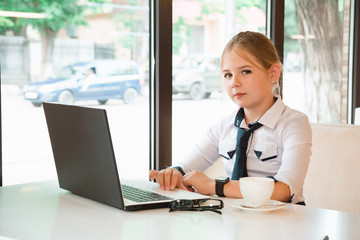 Charismatic girl as a businesswoman in cafe at lunch. Business youth.