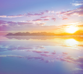 Plakat Beautiful sunset, sunrise with sky reflection at the calm water. Sky and water background 