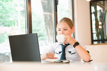 Charismatic girl as a businesswoman in cafe at lunch. Business youth.