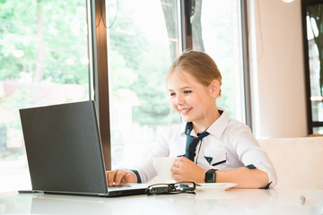 Charismatic girl as a businesswoman in cafe at lunch. Business youth.