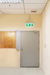 green emergency exit sign to install over the door building construction showing the way to escape