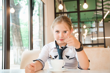 Charismatic girl as a businesswoman in cafe at lunch. Business youth.