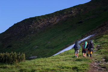 hikers walking in the mountains. goal, success, freedom and achievement concept