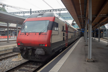 Fototapeta na wymiar Trains stop waiting for passengers in the Bern train station, Switzerland