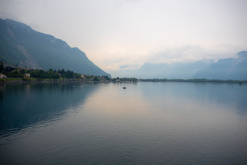 Beautiful panorama view of Geneva lake on small village, mountain and cloudy sky background with copy space