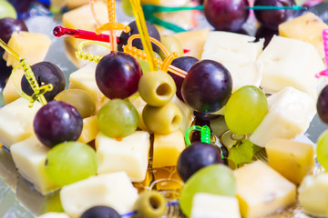 Canape with cheese, grape and olive
