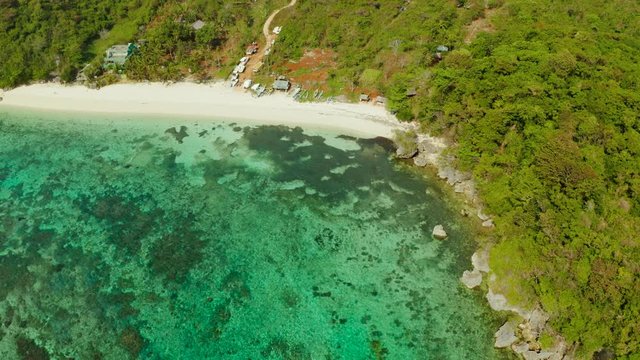 Tropical sandy beach near the blue lagoon and corall reef, aerial view Boracay, Philippines. Ilig Iligan Beach. Summer and travel vacation concept.
