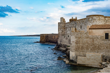 Fototapeta na wymiar Beautiful view of Maniace castle in Ortigia Syracuse, in front of the sea and sky.