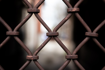 light passage behind a beautiful rusty grille