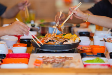 Obraz na płótnie Canvas Selective focus Enjoy of Shabu Shabu and Sukiyaki, Japanese food with grill and pot boil