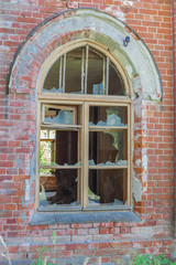 Fototapeta na wymiar broken window in an abandoned house, broken glass, red brick, forgotten residence