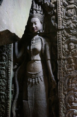 Sculptured wall at Angkor Wat. An Apsara or angel with nice hair style