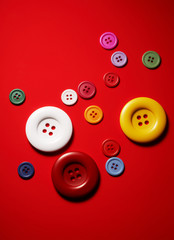 Various buttons over a red background.