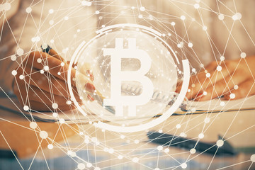 Cryptocurrency hologram over woman's hands writing background. Concept of blockchain. Double...