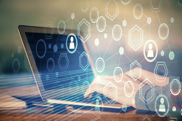 Social network theme hologram with businessman working on computer on background. Concept of world wide web. Multi exposure.