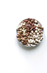 Healthy food. Nuts mix assortment on white grey table top view. Collection of different legumes for background image close up nuts, pistachios, almond, cashew nuts, peanut, walnut. image