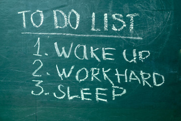 Fototapeta premium To do list it handwritten with white chalk on a green blackboard.