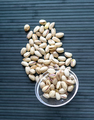 Healthy food  for background image close up pistachios nuts. Texture on top view Nuts pistachio on the cup plate