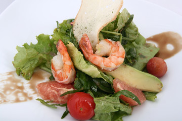 Salad with shrimp, greens, grapefruit and cherry tomatoes. Gourmets