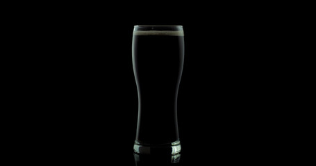 Craft beer in a glass on a black background