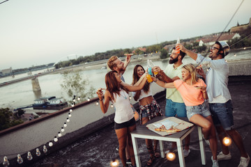 Friends and pizza. Young cheerful people eating pizza and having fun