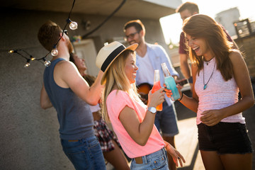 Happy group of young friends having fun in summer