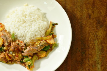 spicy stir fried canned sardines fish with chili and basil leaf on rice
